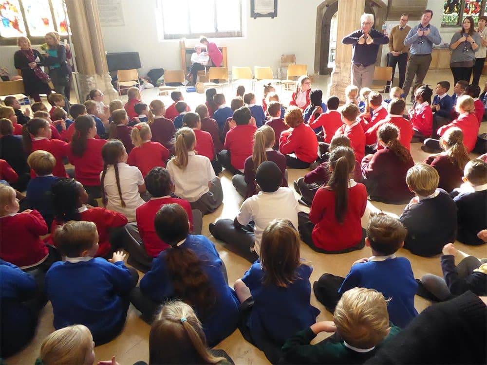 Pupils sitting in a crowd for Cathedral Day