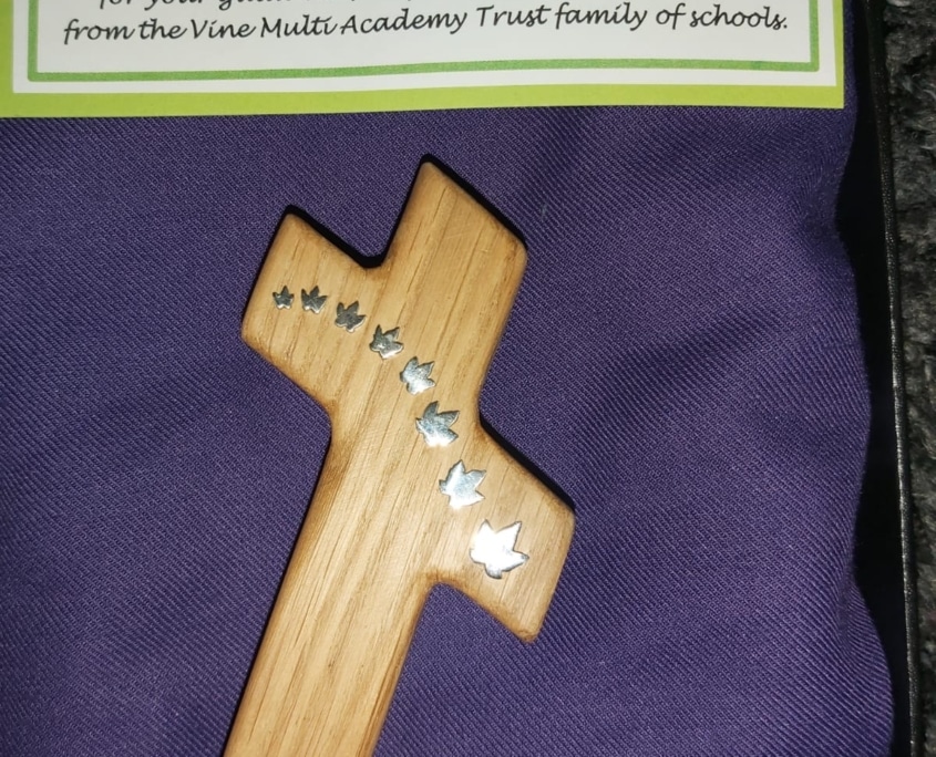 A holding cross in a gift box from the Bishop Stephen
