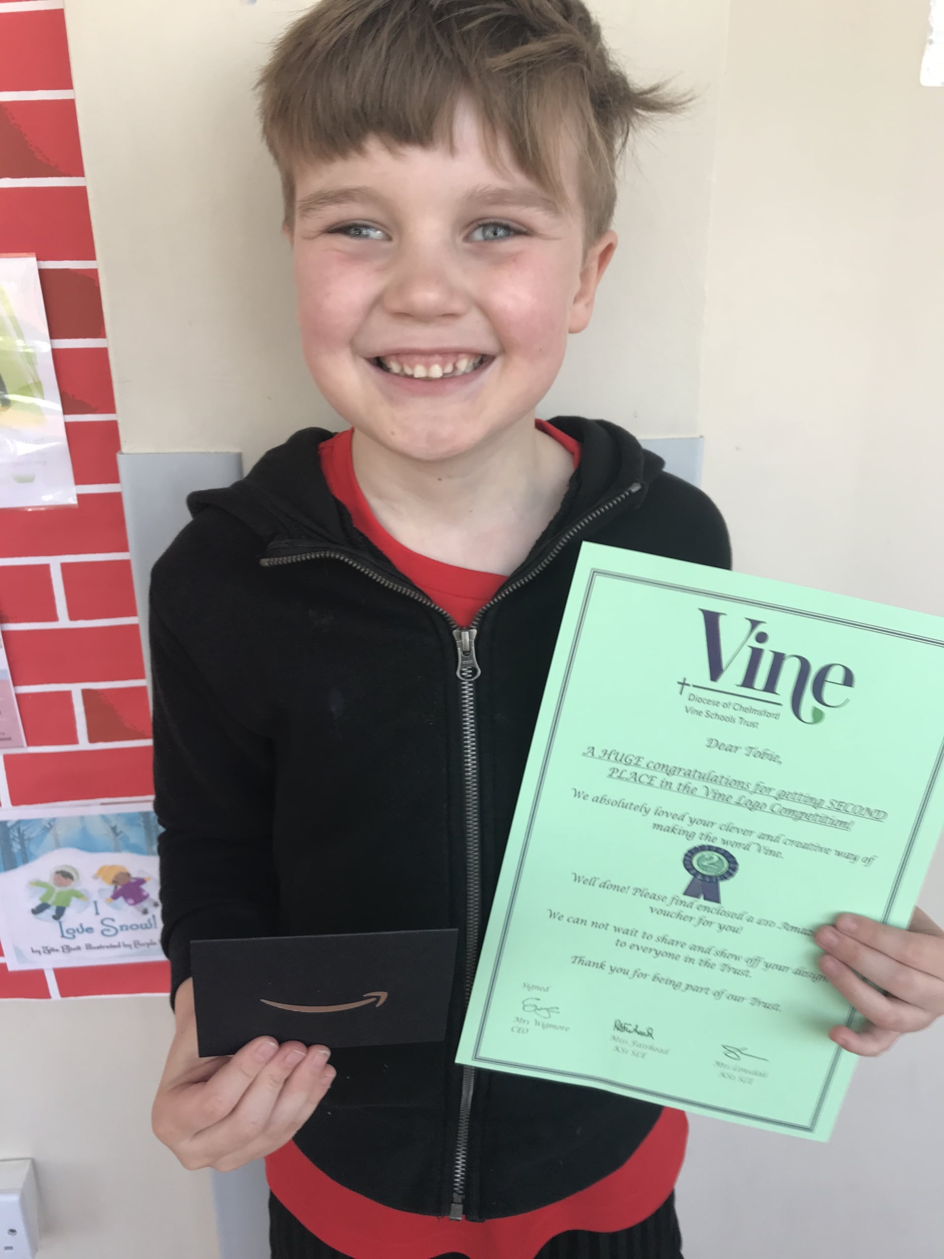 Pupil with Vine Schools Trust Logo Competition Certificate
