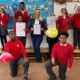 Pupils and staff at St James' Primary celebrating with their Enhanced Healthy School Certificates