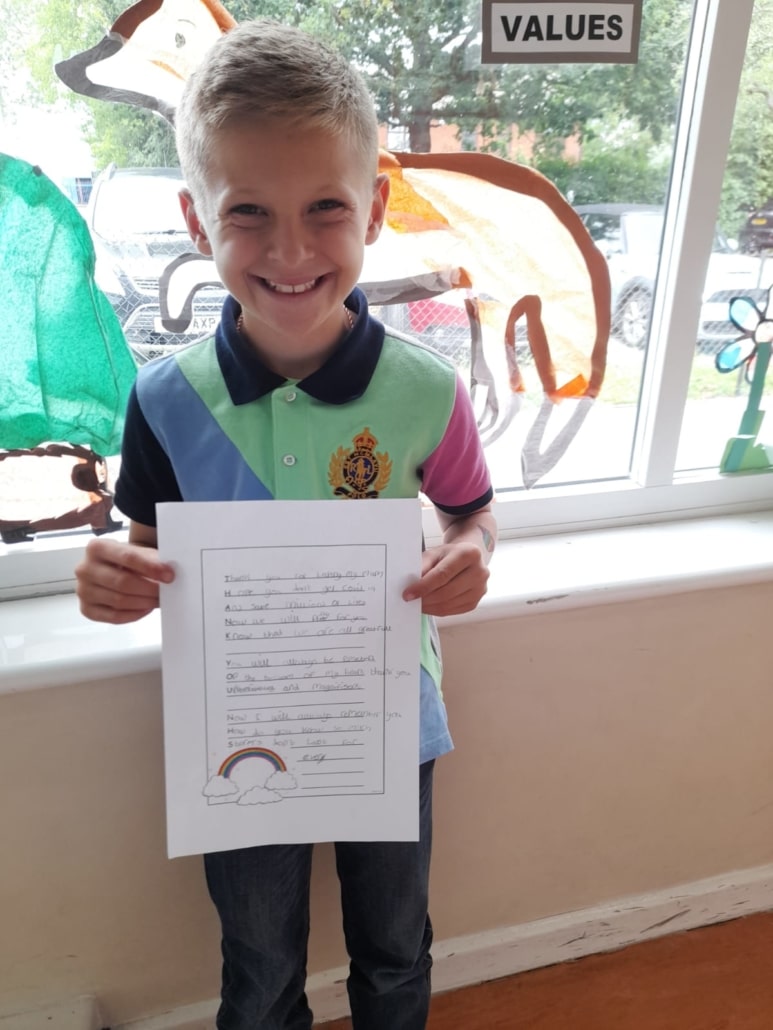 St Margaret's pupil holding letter of thanks to NHS
