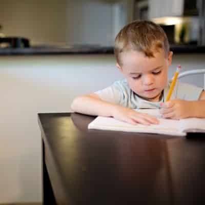 Young boy writing at desk